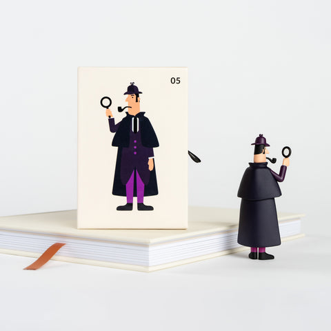 Sherlock Holmes collectible figure in purple coat with magnifying glass