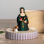 Figurine of Anne Boleyn in historical attire with a dog on a wooden base