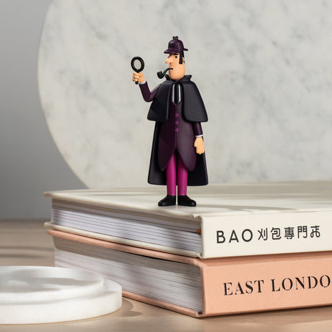 Sherlock Holmes collectible figure displayed beside books