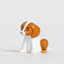 Small dog figurine with a white body and brown ears on a light gray background